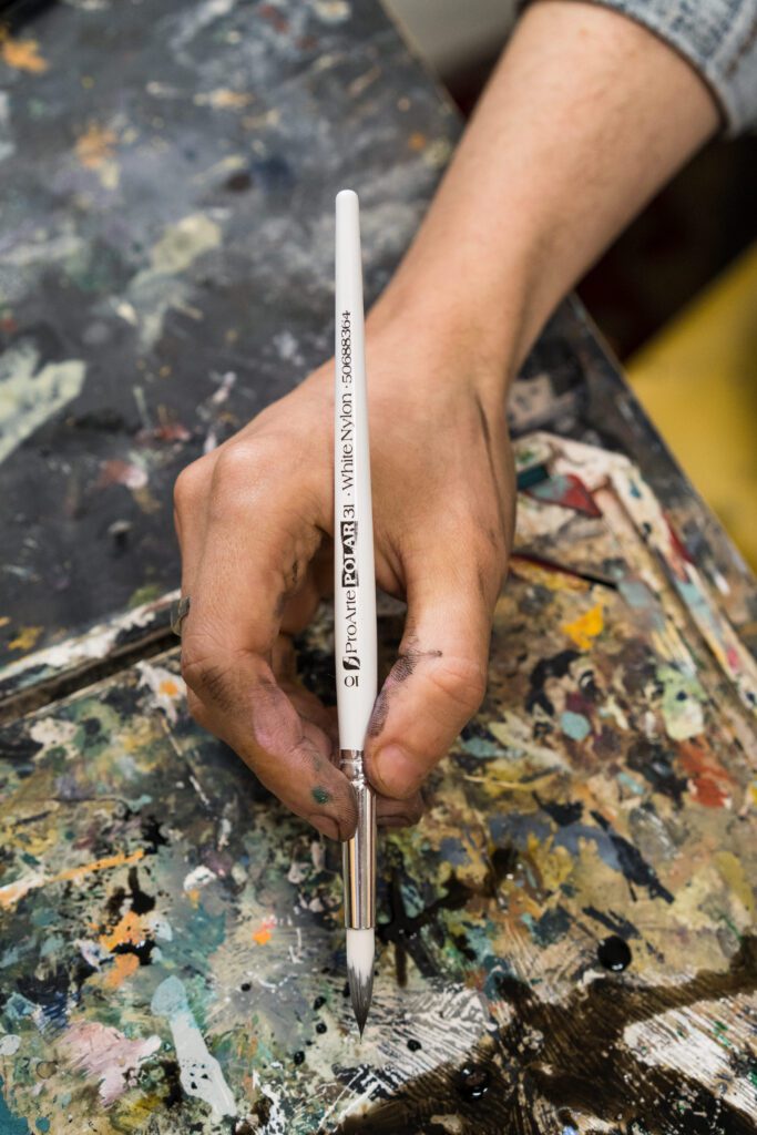 Artist using a medium size paintbrush