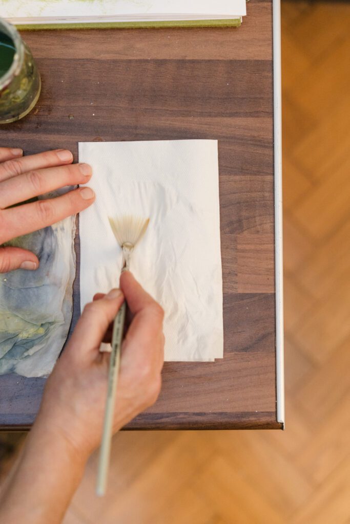 blotting a paintbrush to clean it