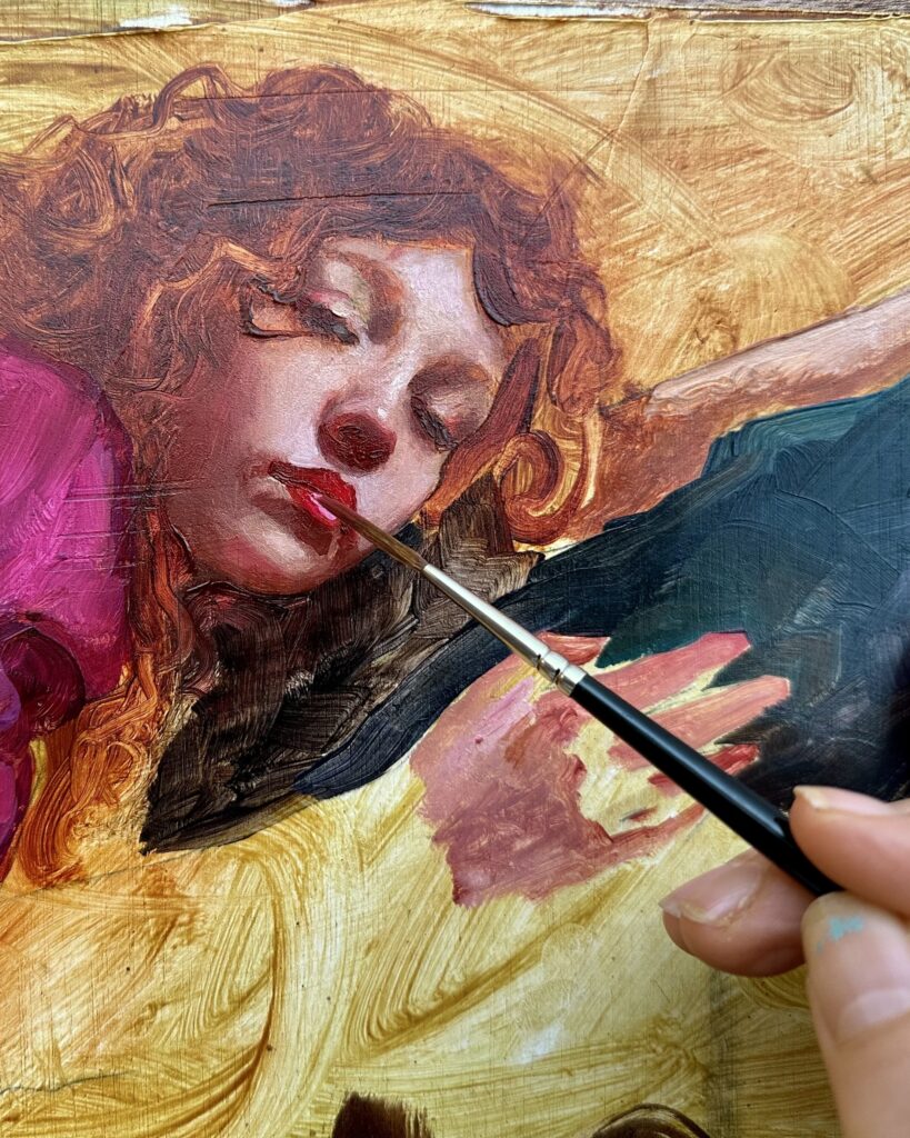 Closeup of a rigger brush adding highlights to the lips of an incomplete painting by Rosso Crimson.